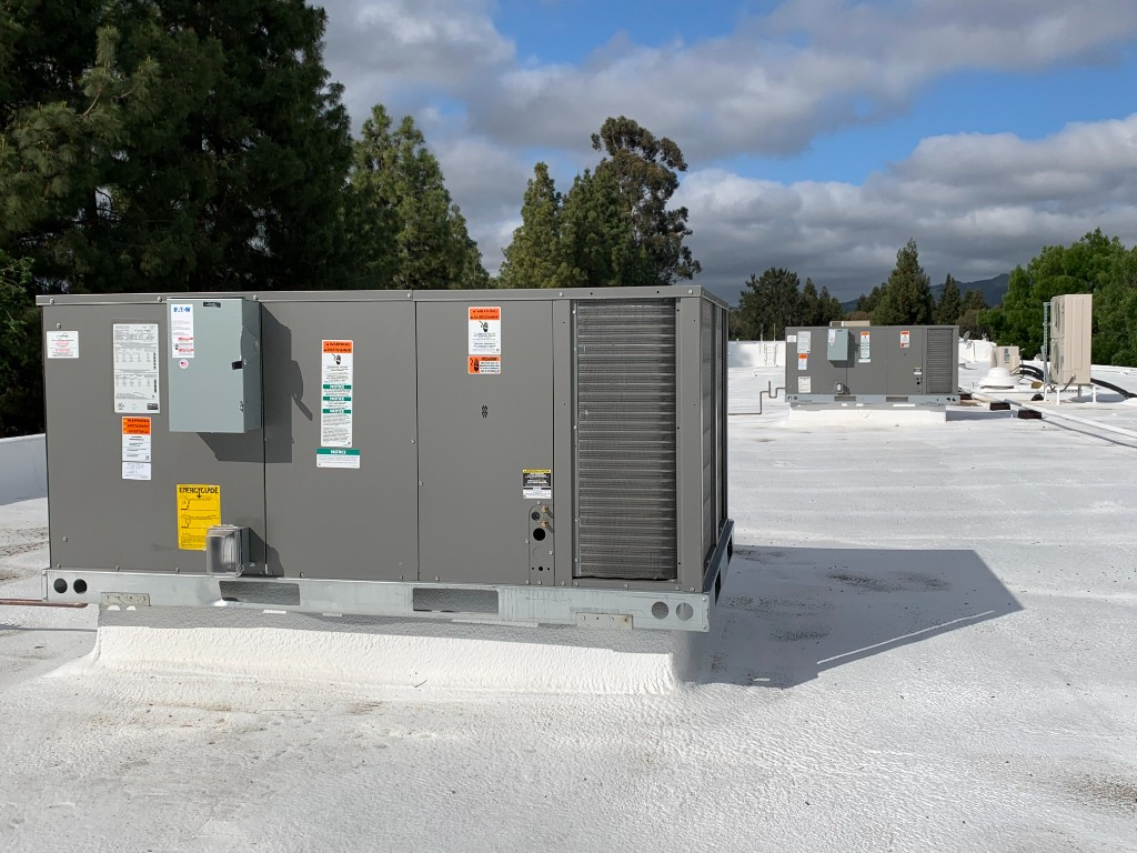 Air Synergy-installed commercial rooftop package HVAC unit on a Bay Area business, with additional rooftop units visible beyond